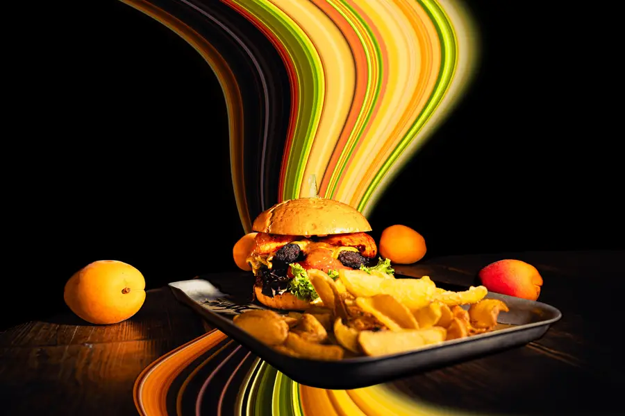 Burger with fries on a tray, colourful light trails behind