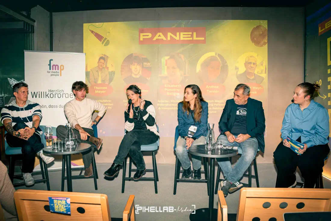 Panel discussion with six people on a stage