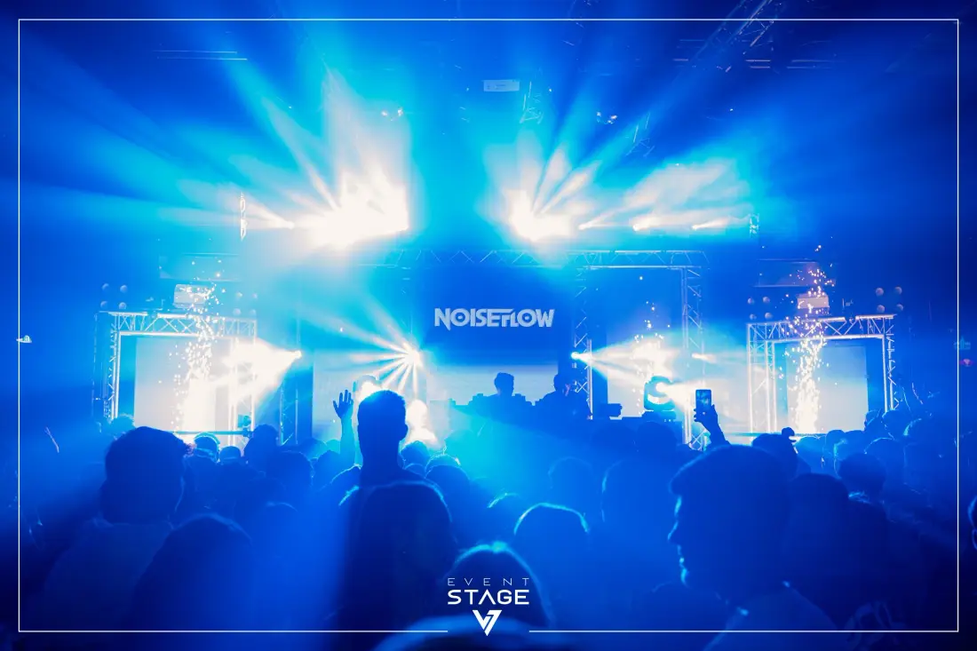 Stage in blue spotlight, the audience in silhouette