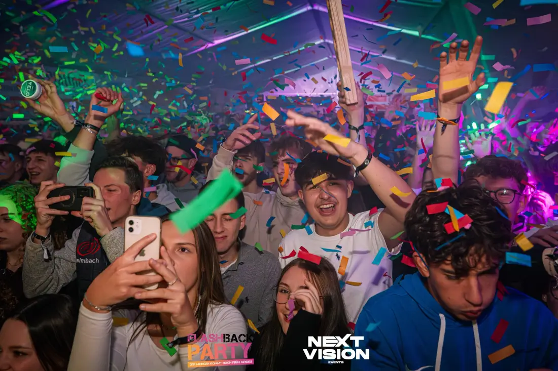 Partygoers in a shower of colourful confetti