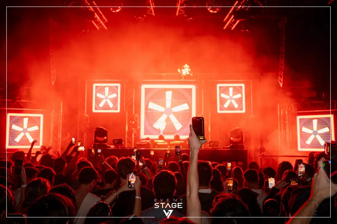 Stage in red light with light panels and audience