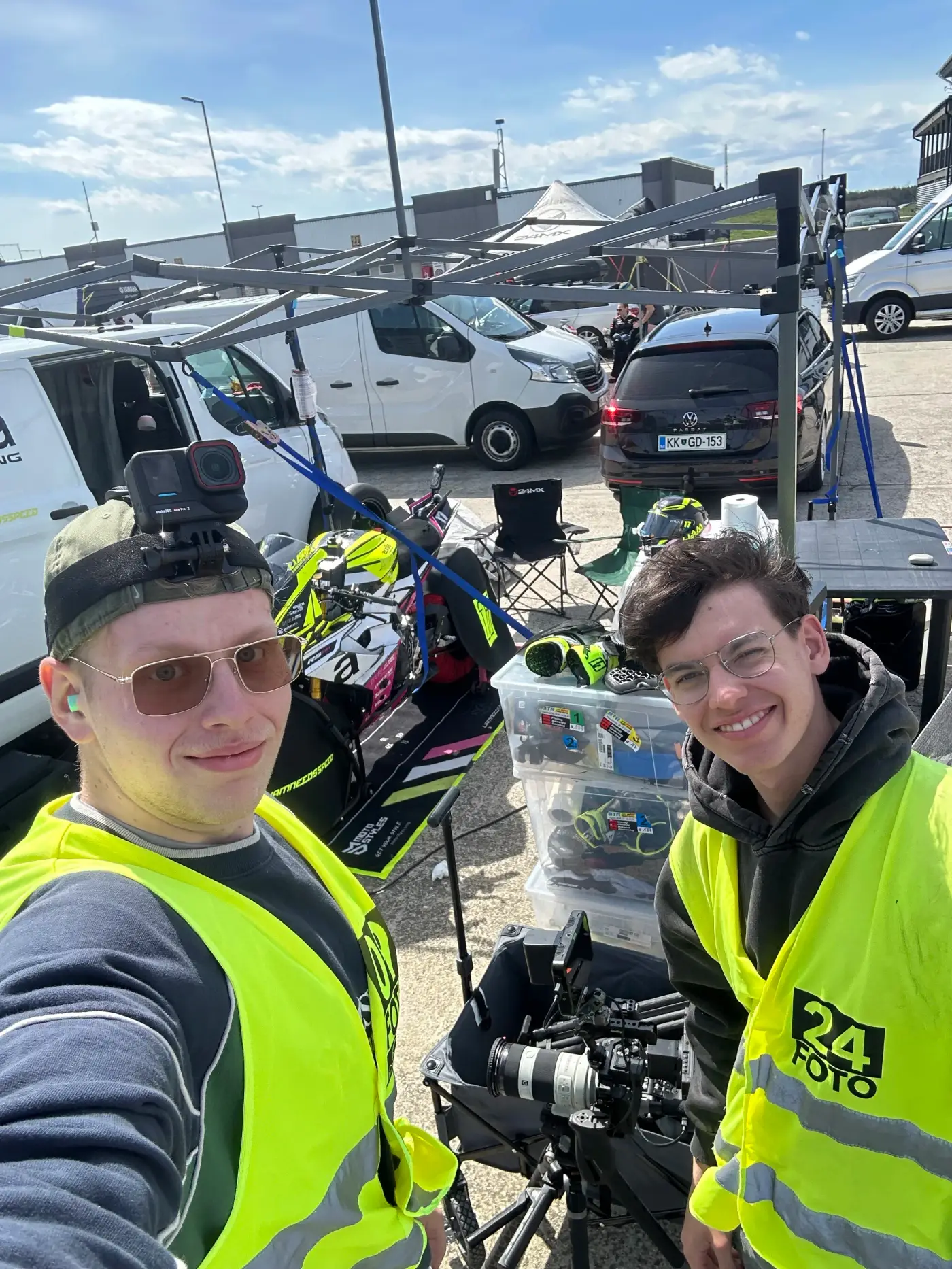 Paul and Bryan in high-visibility vests with camera equipment on a shoot