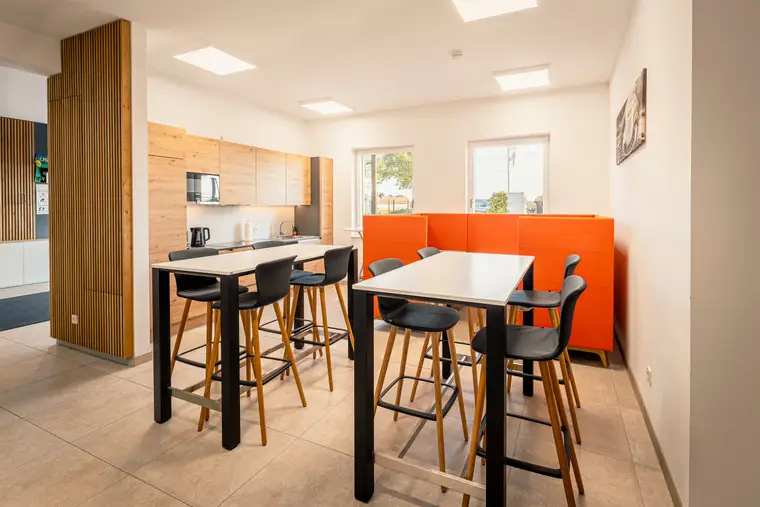 Shared kitchen with high tables in the office building