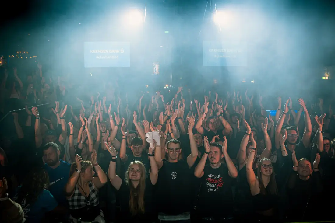 Audience clapping in blue stage light