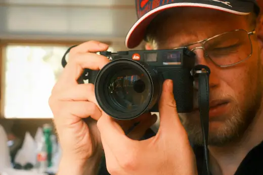 Photographer looking through the viewfinder of his camera
