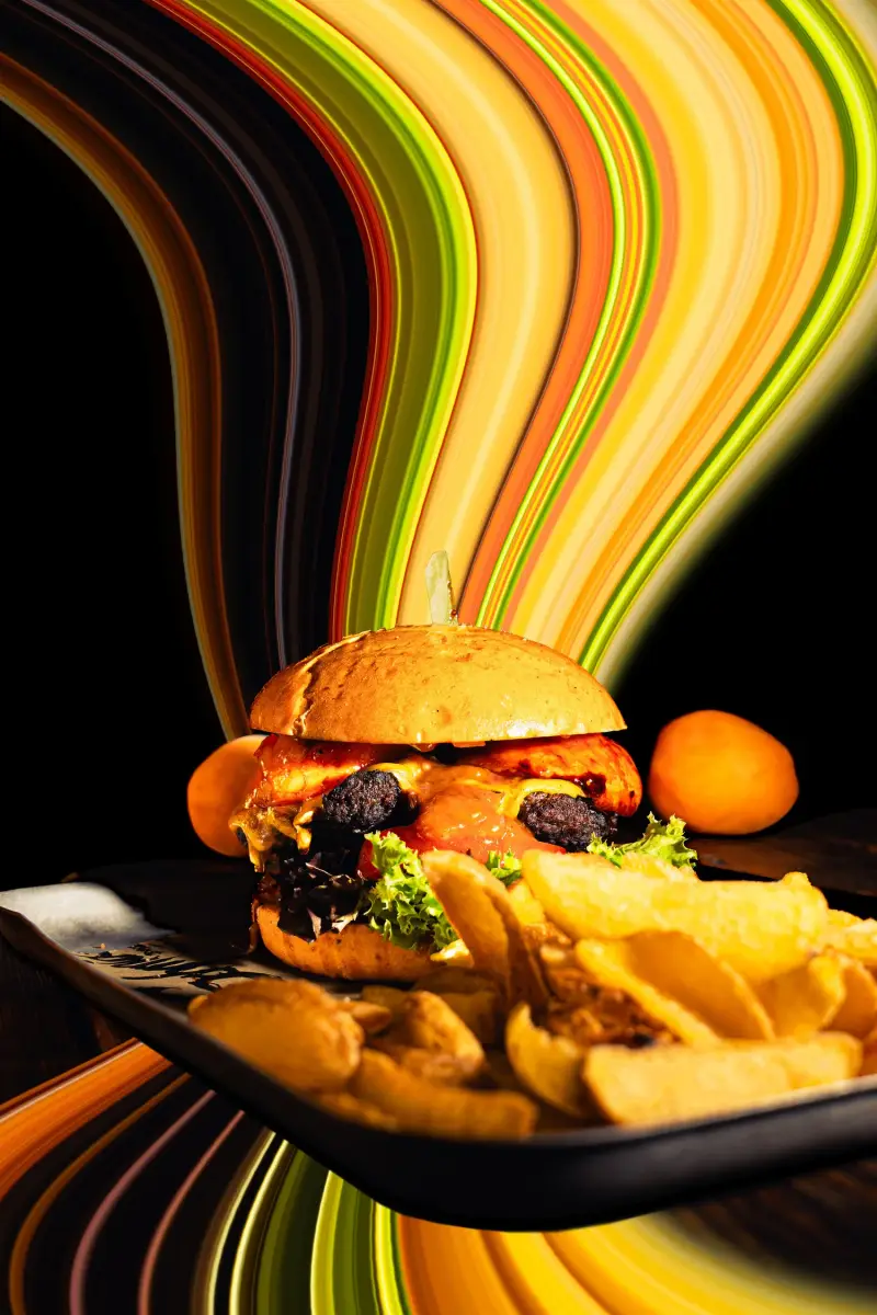 Burger with fries in front of colourful light trails